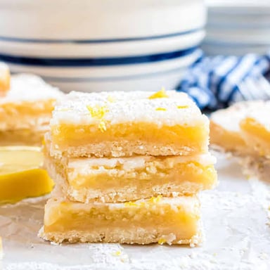 Square lemon bars with a golden crust, bright lemon filling, and a dusting of powdered sugar.