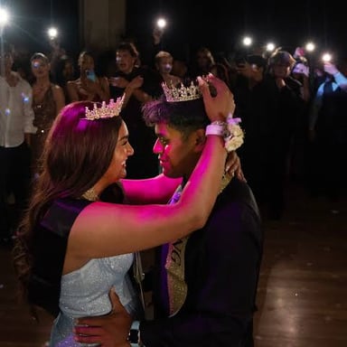 A couple dressed formally at a high school prom