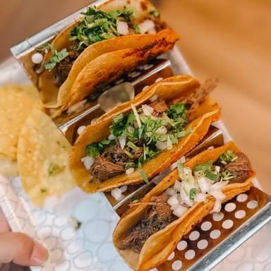 A taco garnished with chopped cilantro.