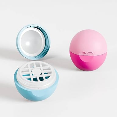 A rounded EOS lip balm container, the brand’s distinctive balm packaging