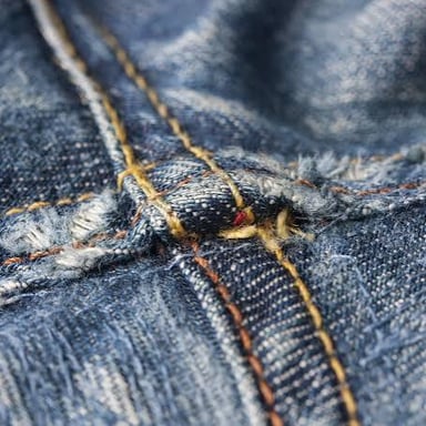 A stitched seam joining two pieces of fabric on a garment.