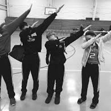A person performing the dab dance move with one arm extended and the head lowered toward the other arm.