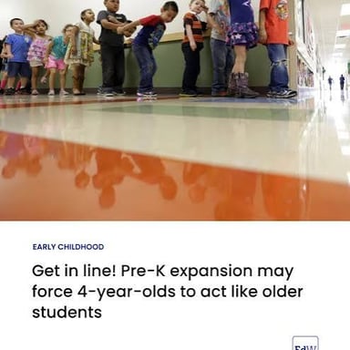 Students waiting in a line, one person behind another.