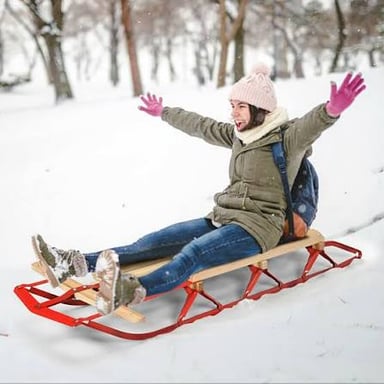 A sled resting on snow, with its runners visible.