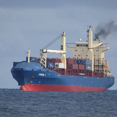 A large freighter ship traveling at sea.