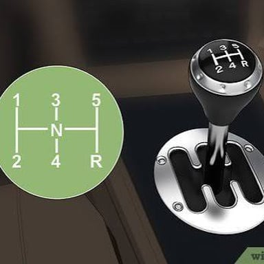 A car’s manual transmission gear shift and clutch controls.