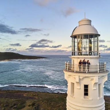 A lighthouse on a cape, a point of land projecting into the water.