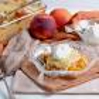 Slices of ripe peaches served with cream.
