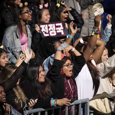 Fans cheering for a popular performer at a concert.