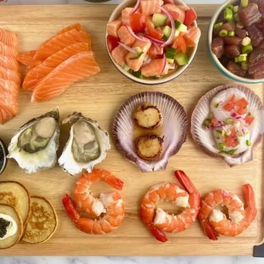 A platter containing scallops, shrimp, and other seafood