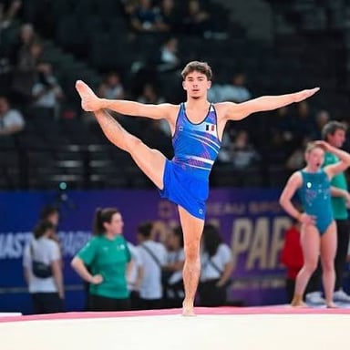 A gymnast wearing a close-fitting leotard during practice.