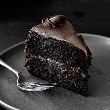 A slice of chocolate cake with a dense, indulgent appearance.