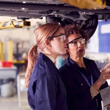 Trainees practicing a task as part of learning a job.