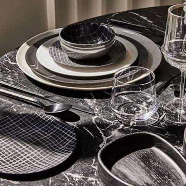 A matching collection of dishes arranged as a complete set.