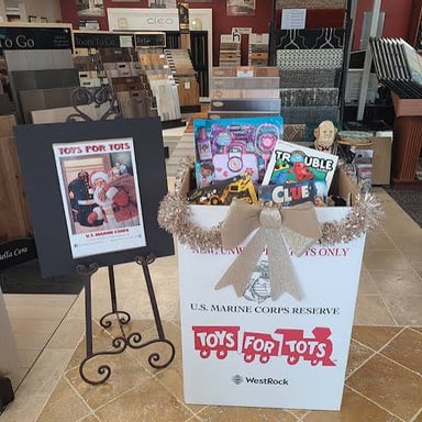 A Toys for Tots collection box filled with donated toys