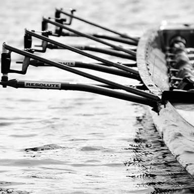 A rowing crew racing in a shell boat.