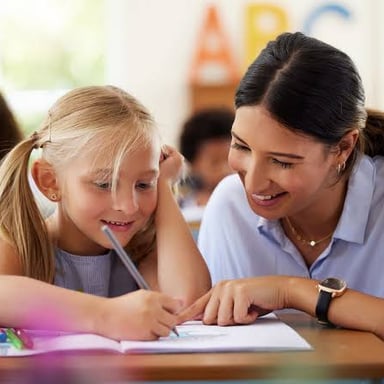 A teaching assistant helping students with coursework.