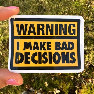 A person hesitating beside a visual warning about a bad decision