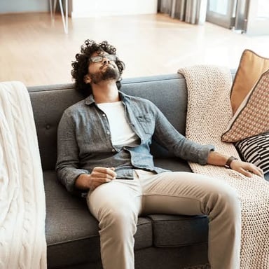 A person relaxing idly on a couch