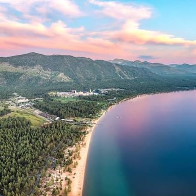 Lake Tahoe surrounded by the forested peaks of the Sierra Nevada.