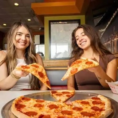 A large pizza is ready to be shared by a group.