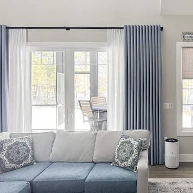 Fabric drapes hanging over a window.