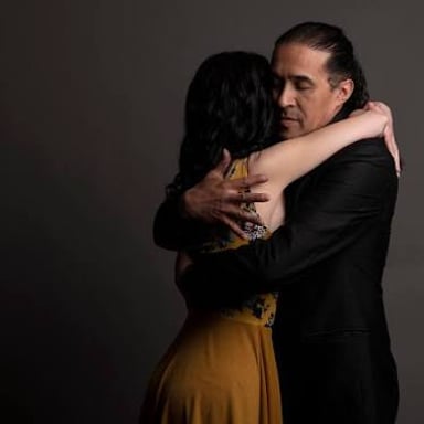 A couple dancing tango, a partnered dance known for close embraces and expressive turns.