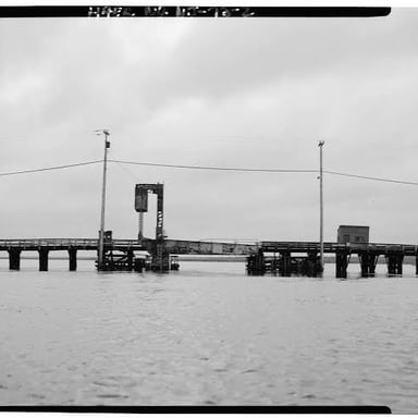 A bridge stretches across a river between its two banks.