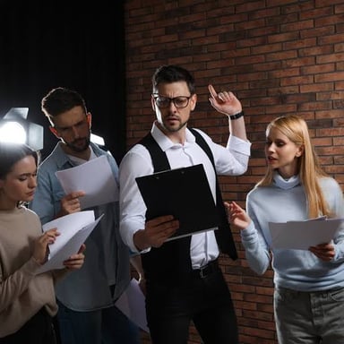 An actor rehearsing dialogue from a script on a stage.