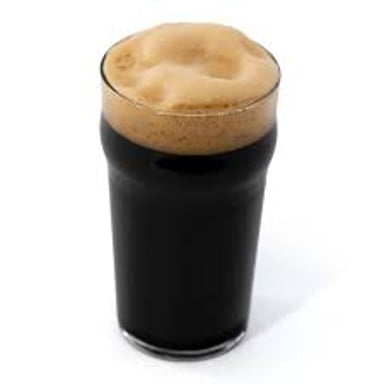 A pint of dark stout beer with a creamy head