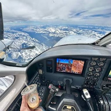A pilot operating an airplane from the cockpit.