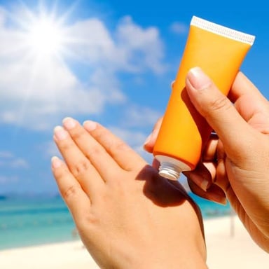 Sunscreen being applied to skin as part of sun protection.