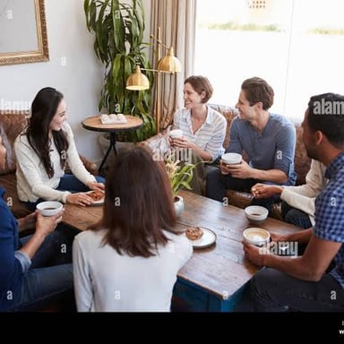 Two friends having a casual conversation at a coffee shop