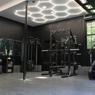 Exercise equipment and weights in an indoor gym.