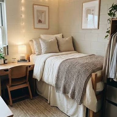 A college dorm room furnished with beds and desks.