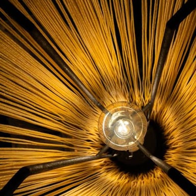 A lit lamp sends light outward into a room.