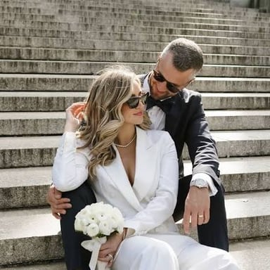 A bride wearing a tailored suit instead of a dress.