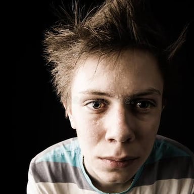 A person showing a worried, uneasy expression.