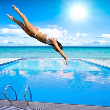 A person plunging into a swimming pool