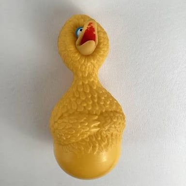 A yellow rubber duck floating in a bathtub.