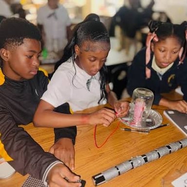 Students conduct a classroom science experiment, representing the S in STEM.