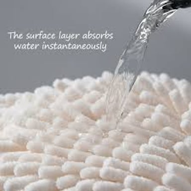 A towel soaking up water from a wet surface.