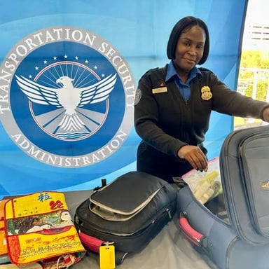 Carry-on luggage being screened at an airport security checkpoint.