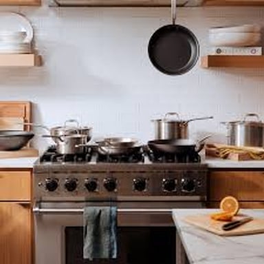 Kitchen cookware showing pots and the shallower pans commonly paired with them.