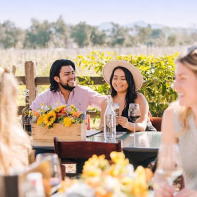 People sampling wine at a winery