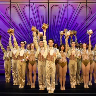 Dancers standing together in a chorus line, evoking the finale of A Chorus Line.