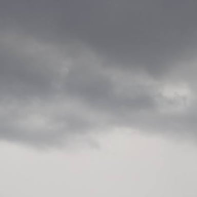 A uniformly gray sky filled with gloomy overcast clouds