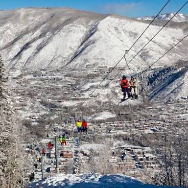 A view of Aspen, Colorado, with the Rocky Mountains and ski slopes nearby.