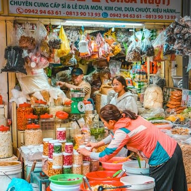 A vendor selling goods at a market stall.