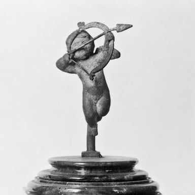 A classical depiction of Eros, the Greek god of love, often shown winged with a bow.